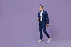 Full size body length young successful employee business man lawyer 20s wear formal blue suit white t-shirt work in office move stroll look aside isolated on pastel purple background studio portrait