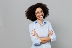 Young fun employee business corporate lawyer woman of African American ethnicity in classic formal shirt work in office hold hands crossed folded look camera isolated on grey color background studio