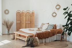 Bedroom interior in Bohemian style with patterned bed. Home interior detail in Boho style
