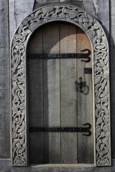 wooden door with artful wood carving ornaments of a viking church