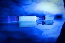 Chemicals glowing under blacklight against a blue background
