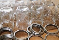 Rows of pickling jars drying upsidedown on a table