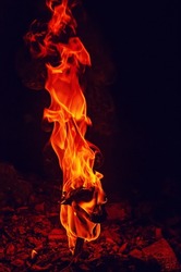 High pillar of fire coming out of stone. Red fire burning flame.
