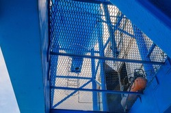 Metal blue industrial mesh. Bottom view of metal industrial structures