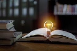 Light bulb on the open book, Idea concept for innovation idea, power of knowledge, power of reading, Self-learning, and education knowledge.