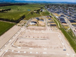 Aerial shots of a developing housing estate in the outer suburbs of Melbourne Australia, roads and gutters have been built, plots of land some already sold are almost ready for houses to be built.