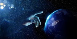 Abstract photo of hand touching planet earth. Planet Earth from space at night. Elements of this image furnished by NASA. Astronomy conception. Distant galaxies and deep space.
