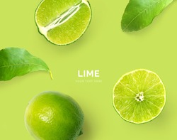 Creative layout made of lime. Flat lay. Food concept. Macro concept. Green background.