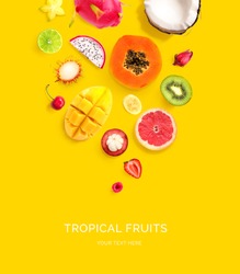 Creative layout made of dragonfruit, papaya, coconut, cherry, kiwi, strawberry, mango, mangosteen, carambola, rambutan, banana on the yellow background. Flat lay. Food concept.