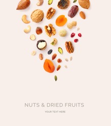 Creative layout made of macadamia, hazelnuts, walnut, cashew, sunflower seeds, peanut, almond, dates, pecan, fig, pumpkin seeds, pistachio, raisin,  cranberry on the beige background. Food concept.