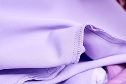 Close-up of Overlock stitch and straight stitch on purple dress
