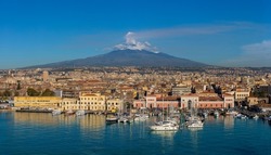 Port of Catania, Sicily. Mount Etna in the background.