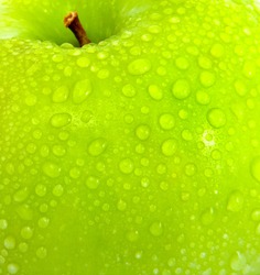 apple in green with water drops on its surface