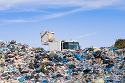 Landfill waste disposal. Garbage truck unloads rubbish in landfill. 