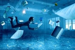 Business man with paper and pen underwater