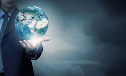Hand of businessman holding earth planet. Elements of this image are furnished by NASA