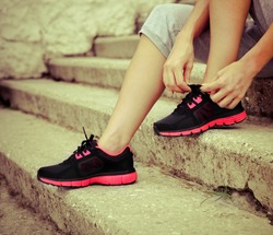 Athlete girl trying running shoes getting ready for jogging