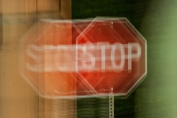 A blurry stop sign seen through impaired vision or distorted perceptions.