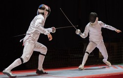 Two man fencing athletes fight on professional sports arena 
