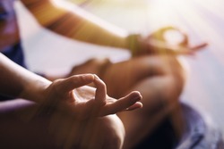 Closeup of woman's hands meditating indoors