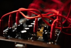 Analog synthesizer with audio cables. Professional modular synth device for electronic music production in sound recording studio