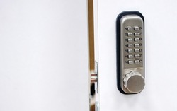 Digital door lock. Door safety system, code keypad closeup. Open door with control system using digital locking and password to acces