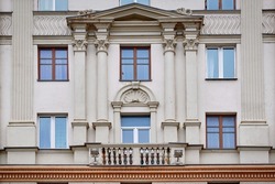 Balconies with columns on facade of old residential building. Stalinist architecture, building on Independence Avenue. Stalin Empire style. Balcony of soviet building