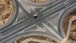 A crossroads and a passenger car in the middle of the desert outside the city. High quality photo