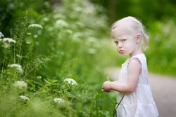 Portrait of a very angry little girl outdoors