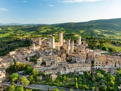 Aerial view of famous medieval San Gimignano hill town with its skyline of medieval towers, including the stone Torre Grossa. UNESCO World Heritage Site. Province of Siena, Tuscany, Italy.