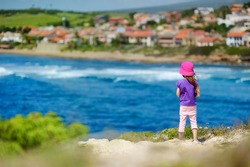Cute little girl enjoying a view of seascape of Sardinia, Italy