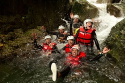 Group Of Active Young People During A Canyoning Expedition In Ecuadorian Rainforest