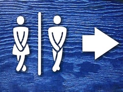 public toilet sign board with white woman and man figure and arrow on blue background or surface with noise effects. public toilet or wc sign board photo with selective focus and copy space on blue