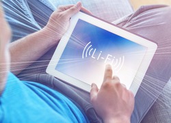 Li-Fi W-Lan technology, internet and networking concept - Young man activates Li-Fi High speed connection