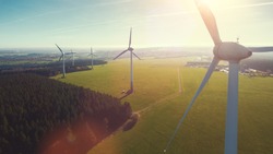 Wind turbines and agricultural fields on a summer day - Energy Production with clean and Renewable Energy - aerial shot, analog image style