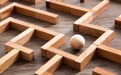 Wooden ball in a maze and thinking the best way to go.