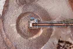 Stone grinder and conveyor belt in a large Quarry - Top down aerial view