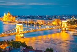 Scenic top view of the Hungarian Parliament and Chain Bridge on the Danube river at night. Location place Budapest, Hungary, Europe. Popular european travel destination. Discover the beauty of earth.