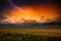Lightning illuminates ominous storm clouds over farmland. Adverse weather conditions. Location place agricultural region of Ukraine, Europe. Wallpaper force of nature. Discover the beauty of earth.