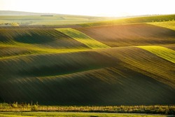 Perfect morning sunlight on the wavy fields and farmland. Location place South Moravian region, Czech Republic, Europe. Concept of agrarian industry. Minimalist scene. Discover the beauty of earth.