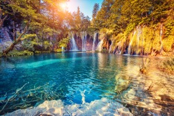 Majestic view on turquoise water and sunny beams in the Plitvice Lakes National Park. Croatia. Europe. Dramatic unusual scene. Beauty world. Retro filter and vintage style. Instagram toning effect.