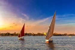 Sailboat on Nile at sunset in a summer evening