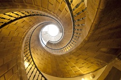 View up a dramatic triple spiral staircase.