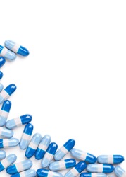 Blue and white pills frame corner on white background