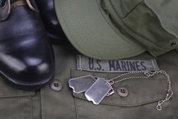 U.S. MARINES Branch Tape with dog tags and boots on olive green uniform background