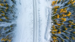 Top view at the wintry two way rail road in evergreen forest. Winter in Russia