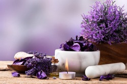 Spa massage setting, lavender product, oil on wooden background