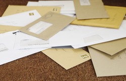 Closeup of a pile of mail on doormat