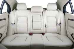 Back passenger seats in modern luxury car, frontal view, white leather