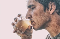 Man is drinking dirty water from the glass cup
